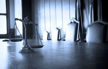 justice scales on the desk in the courtroom
