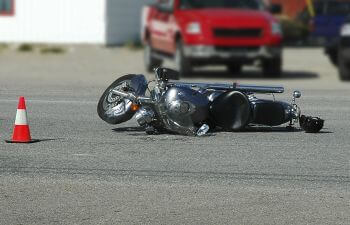 motorcycle and crashe helment lying on the road after auto accident